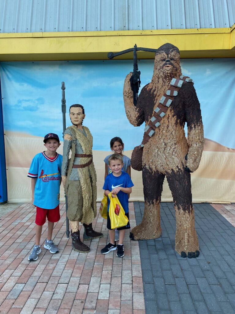 Max, who has high functioning autism and ADHD, and his brother and sister with Chewbacca at Lego Land in Winter Haven, Florida.